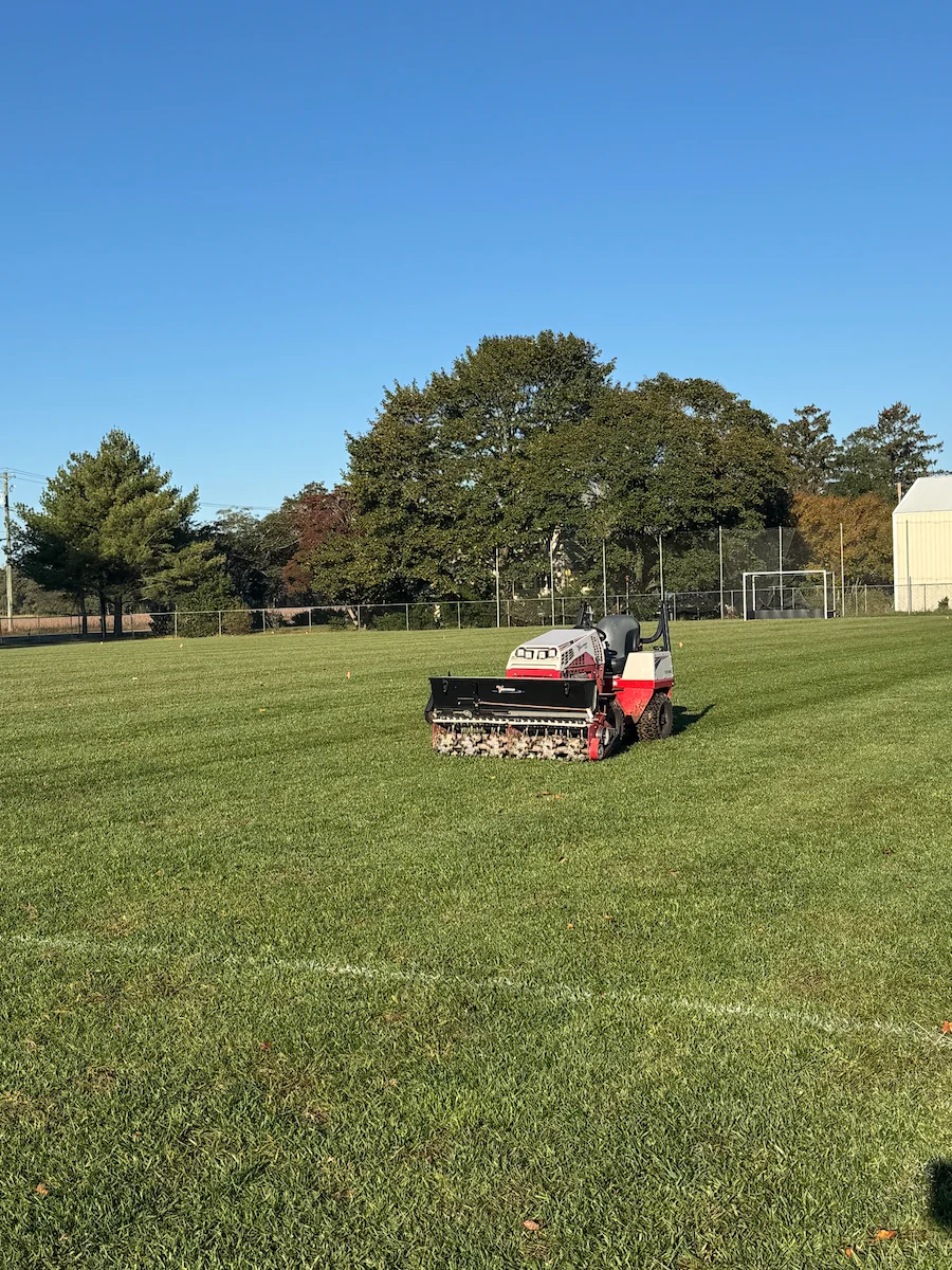Core aeration machine on green field Harvest Turf Care Sussex County DE
